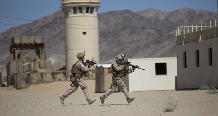 Two U.S. Army soldiers run for cover during a live training exercise
