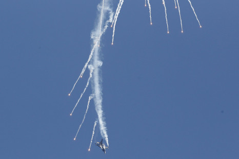 A Turkish F-16 fires maneuvers during an airshow