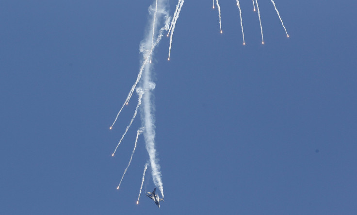 A Turkish F-16 fires maneuvers during an airshow