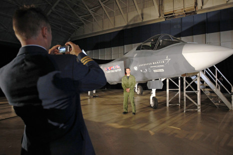 A Canadian service member next to an F-35. 