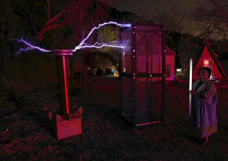 A person demonstrates the power of the Faraday cage