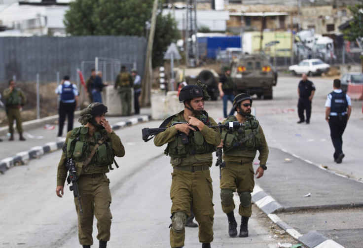 Israeli soldiers walk in formation while on patrol 