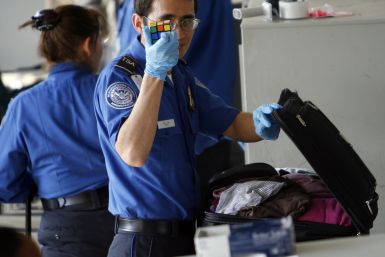 TSA staff check bags at Los Angeles International Airport