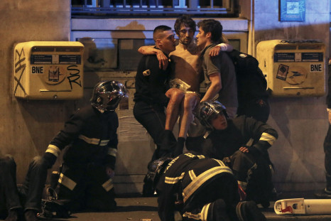 Security services carry away an injured man after Paris attacks