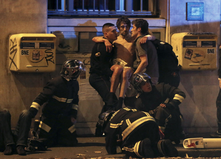 Security services carry away an injured man after Paris attacks