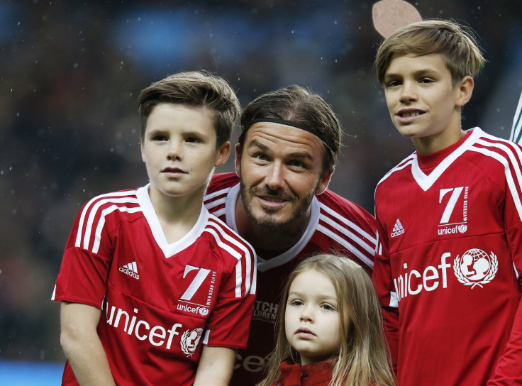 David Beckham and his children Cruz, Romeo and Harper pose before a charity football match