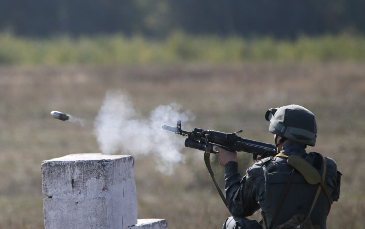A Ukrainian soldier fires a weapon during a drill