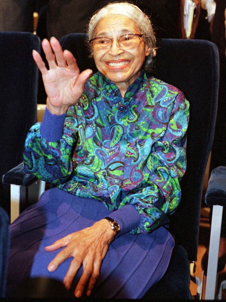 Rosa Parks waves during an event in 1998. 