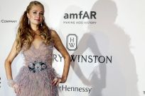 U.S. socialite Paris Hilton poses during a photocall as she arrives to attend the amfAR's Cinema Against AIDS 2015 event