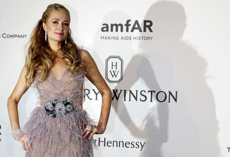 U.S. socialite Paris Hilton poses during a photocall as she arrives to attend the amfAR's Cinema Against AIDS 2015 event