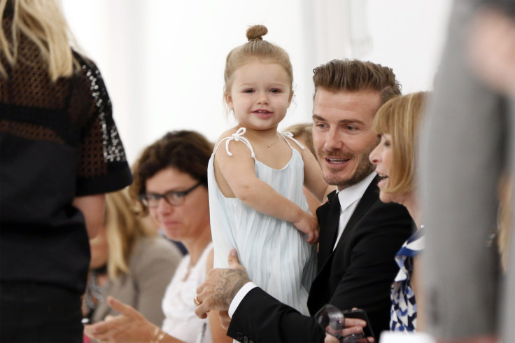 Former England soccer captain David Beckham holds his daughter Harper 