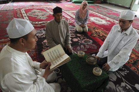 People from the Hui minority read from the Koran