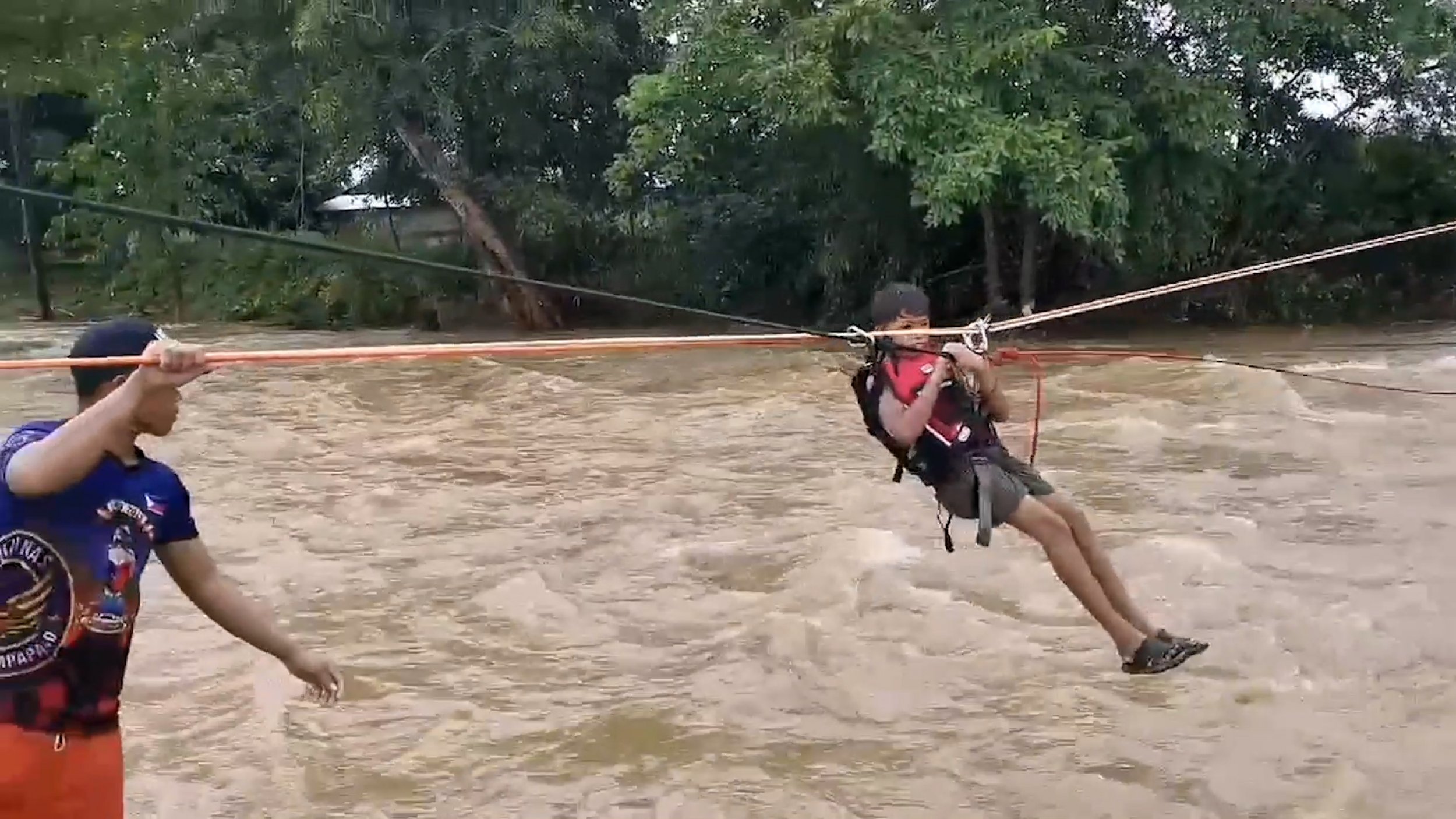 Video Shows Trapped Families Use Zipline To Cross Flooded River After Severe Storm