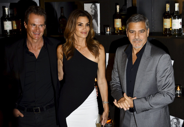 Cindy Crawford poses with her husband and model Rande Gerber (L) and U.S. actor George Clooney