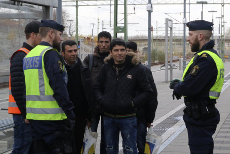 Swedish police talk to people at a train station near Malmo. 