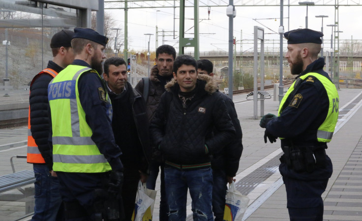 Swedish police talk to people at a train station near Malmo. 