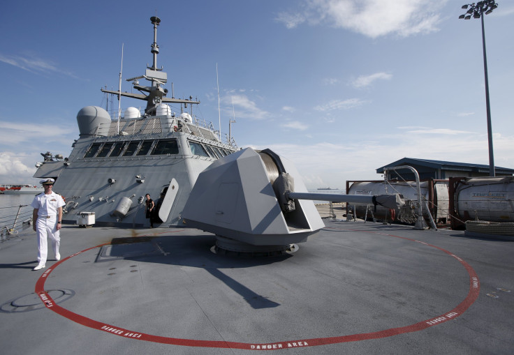 A Navy officer walks across the deck of a Littoral Combat ship.