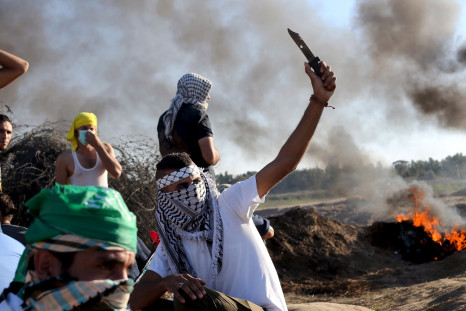 A Palestinian protester holds a knife during clashes.  