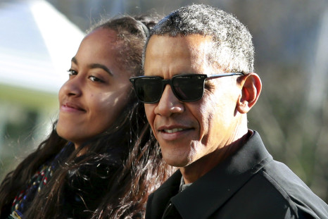 U.S. President Barack Obama walks with his daughter Malia 