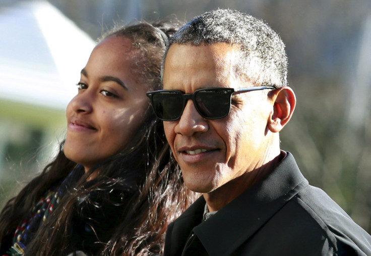 U.S. President Barack Obama walks with his daughter Malia 