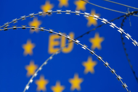 An E.U. sign behind razor wire at a protest in Slovenia.