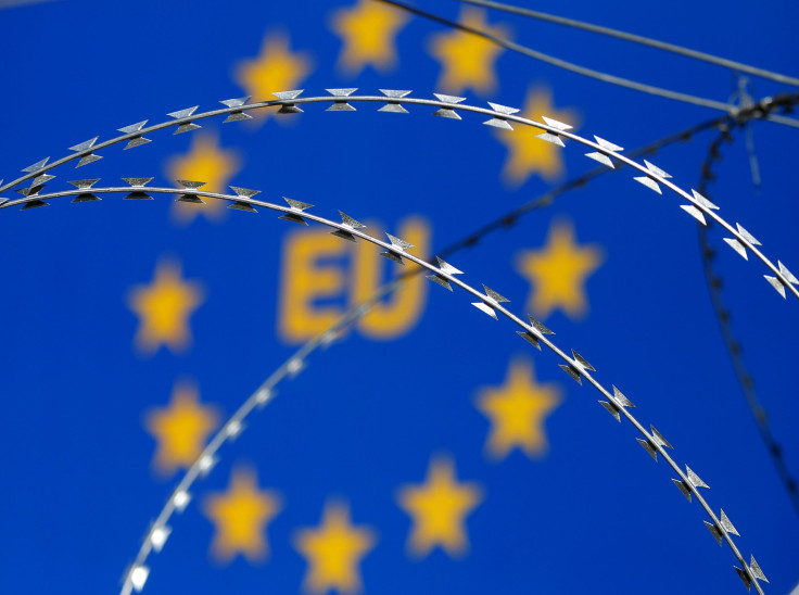 An E.U. sign behind razor wire at a protest in Slovenia.