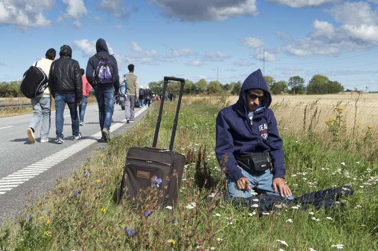 A refugee takes time to prays while journeying through Denmark. 