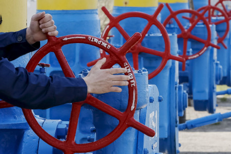 An employee turning a valve at a gas compressor station near Kiev. 
