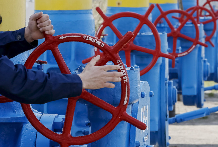 An employee turning a valve at a gas compressor station near Kiev. 