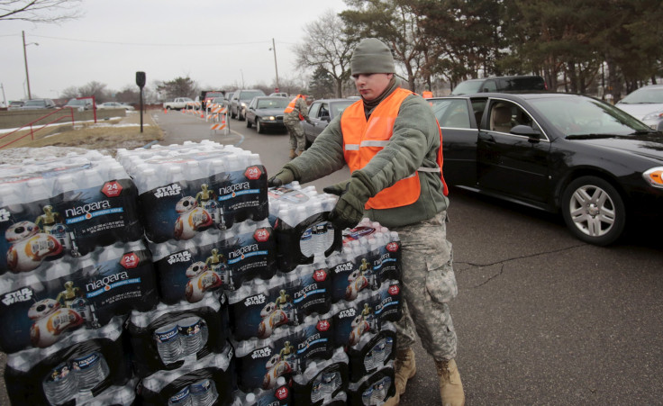 A National Guard member helps distribute water in Flint, Michigan. 