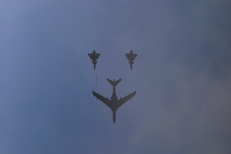 Three military aircraft fly above Beijing during celebrations. 