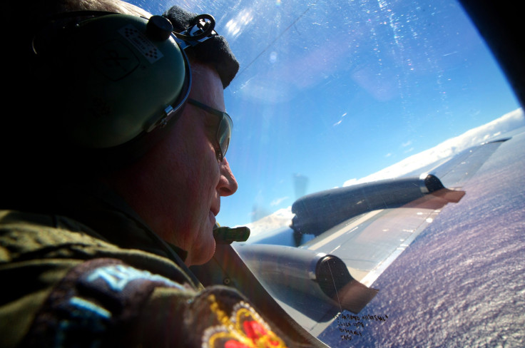 An airmen looks out at the ocean in the search for MH370.