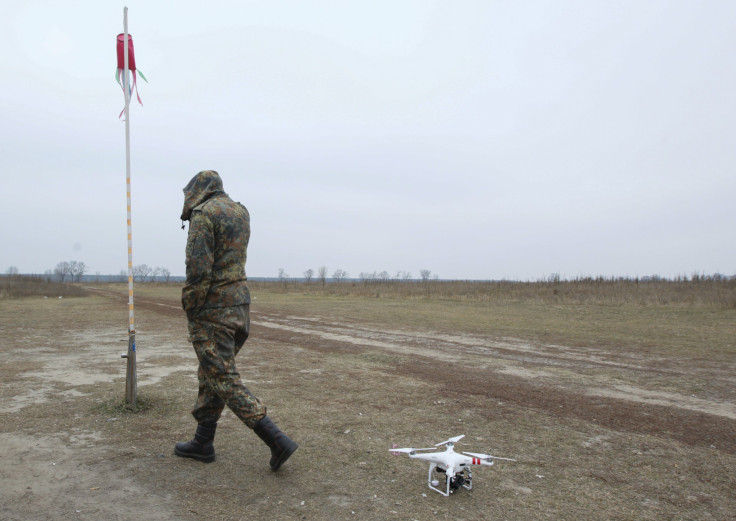 A drone rests as a Ukrainian soldier walks by. 