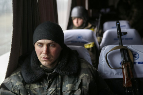A Ukrainian serviceman sits on a bus before returning home. 