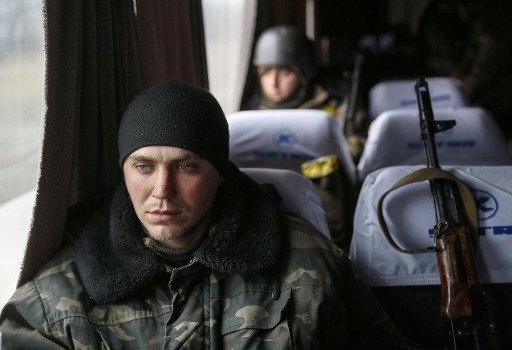 A Ukrainian serviceman sits on a bus before returning home. 