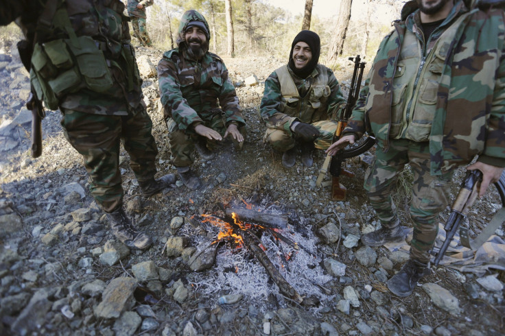 Syrian Army fighters warm themselves after a battle to recapture the coastal Syrian town of Latakia. 