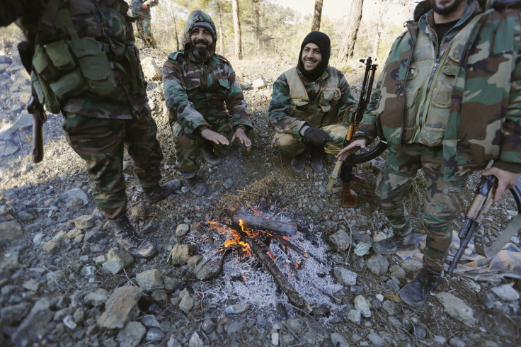 Syrian Army fighters warm themselves after a battle to recapture the coastal Syrian town of Latakia.