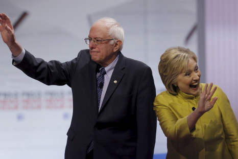 Hillary Clinton and Bernie Sanders wave before the start of a debate. 