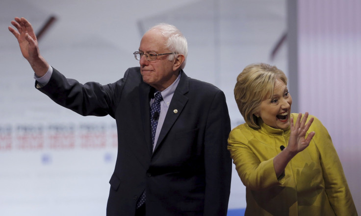 Hillary Clinton and Bernie Sanders wave before the start of a debate. 