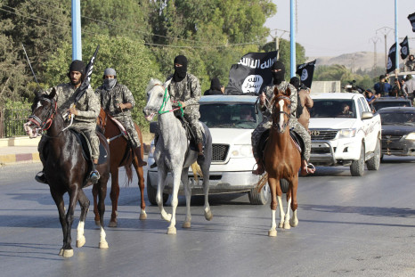 ISIS fighters ride horses during a parade in Raqqa, Syria. 