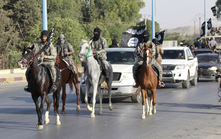 ISIS fighters ride horses during a parade in Raqqa, Syria. 