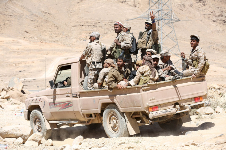 Saudi Arabia-backed troops ride a truck inside Yemen. 