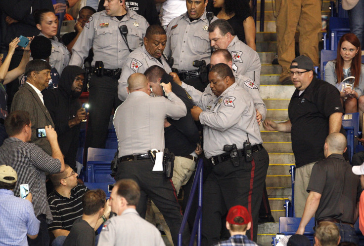A protester is escorted by police from a Donald Trump rally.  