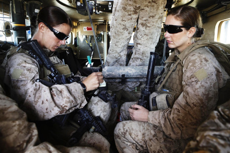Two female US marines travel inside an armored vehicle in Afghanistan. 