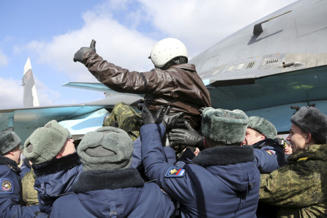 A Russian pilot is lofted in the air after returning from the Syrian war.