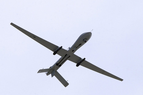 A predator drone armed with hellfire missiles flies over a military base in Nevada. 