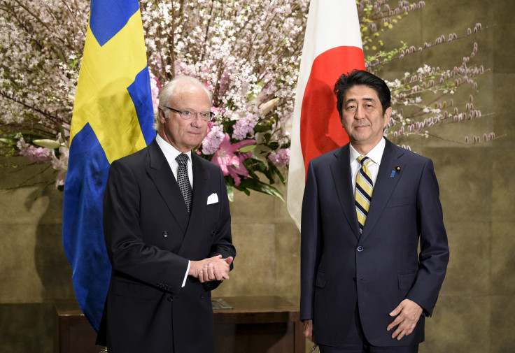 King Carl XVI Gustaf of Sweden (L) and Japanese Prime Minister Shinzo Abe