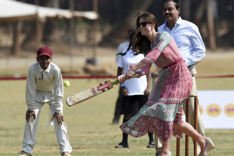 Catherine, Duchess of Cambridge, is watched by former Indian cricketer Dilip Vengsarkar (R) 
