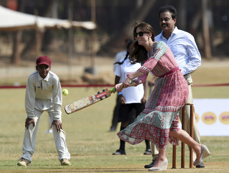 Catherine, Duchess of Cambridge, is watched by former Indian cricketer Dilip Vengsarkar (R) 