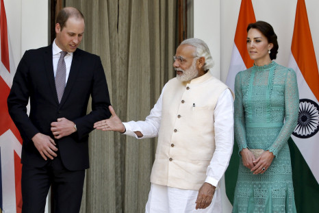 Britain's Prince William shakes hands with India's Prime Minister Narendra Modi (C) as Catherine, Duchess of Cambridge looks on